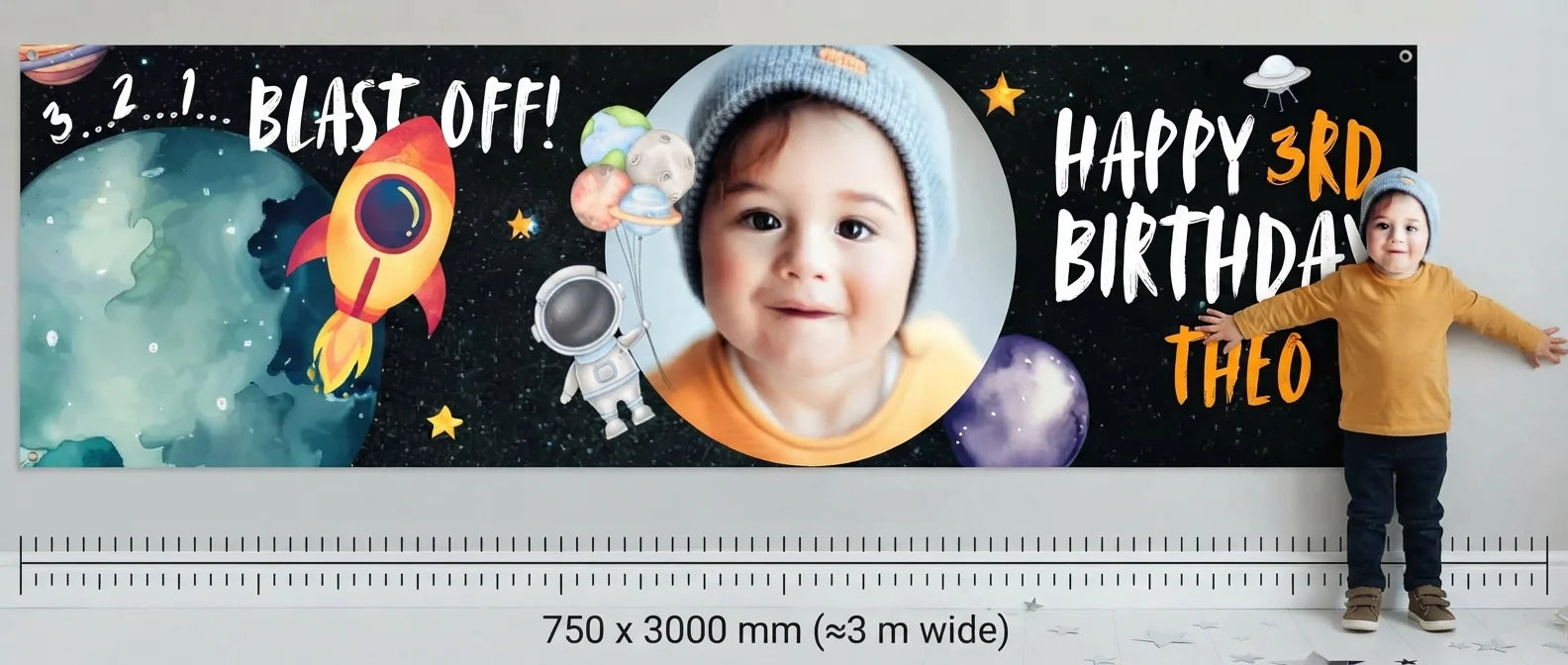 Person standing beside the Blast Off Outerspace Birthday Party Banner for scale, with size guide showing 750 x 3000 mm