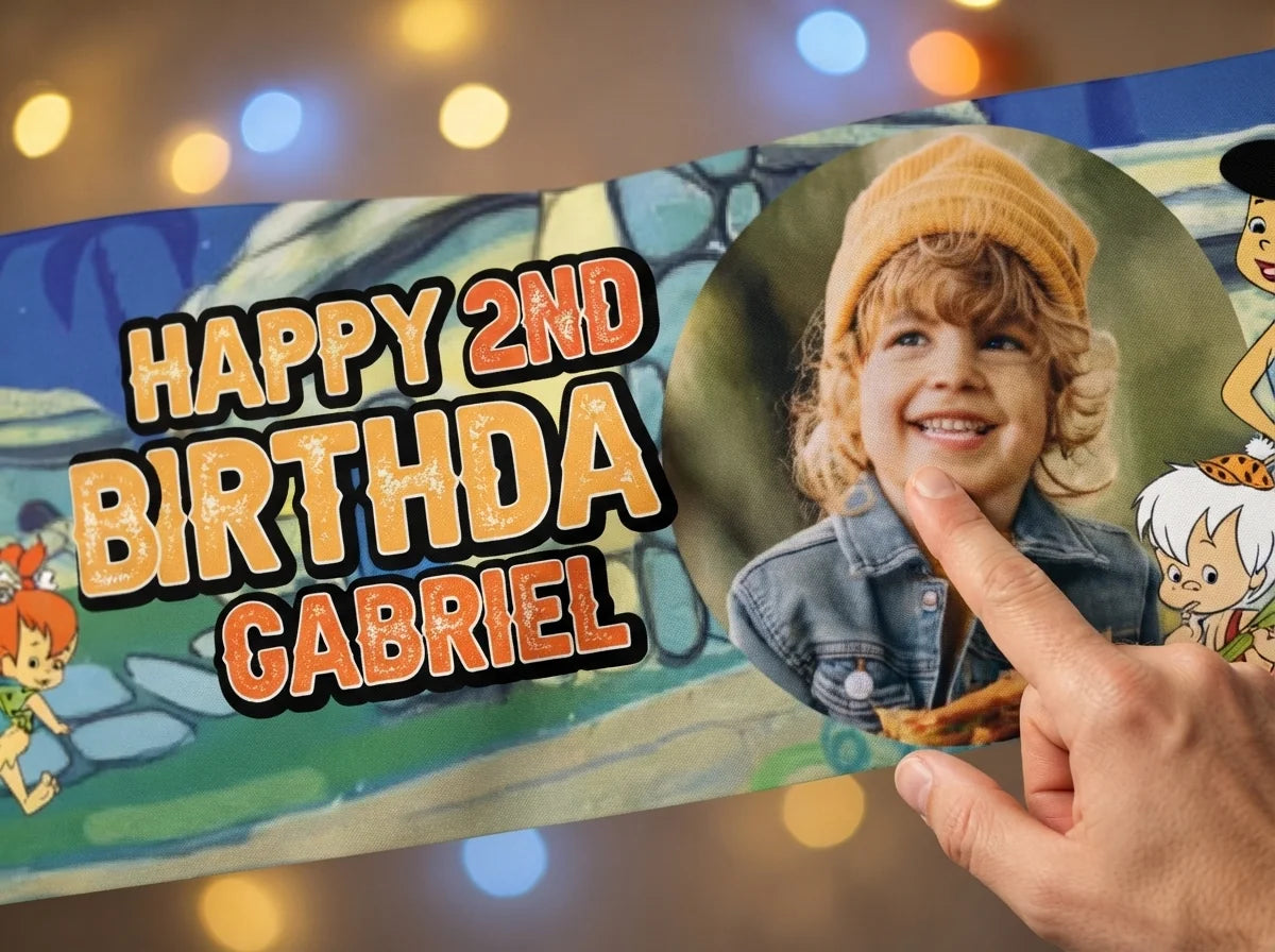 Close-up of the personalised name and photo printed on the Flintstones Birthday Banner
