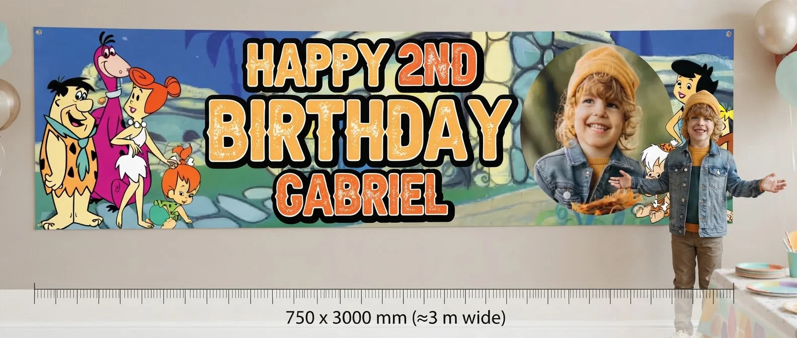 Person standing beside the Flintstones Birthday Banner for scale, with size guide showing 750 x 3000 mm