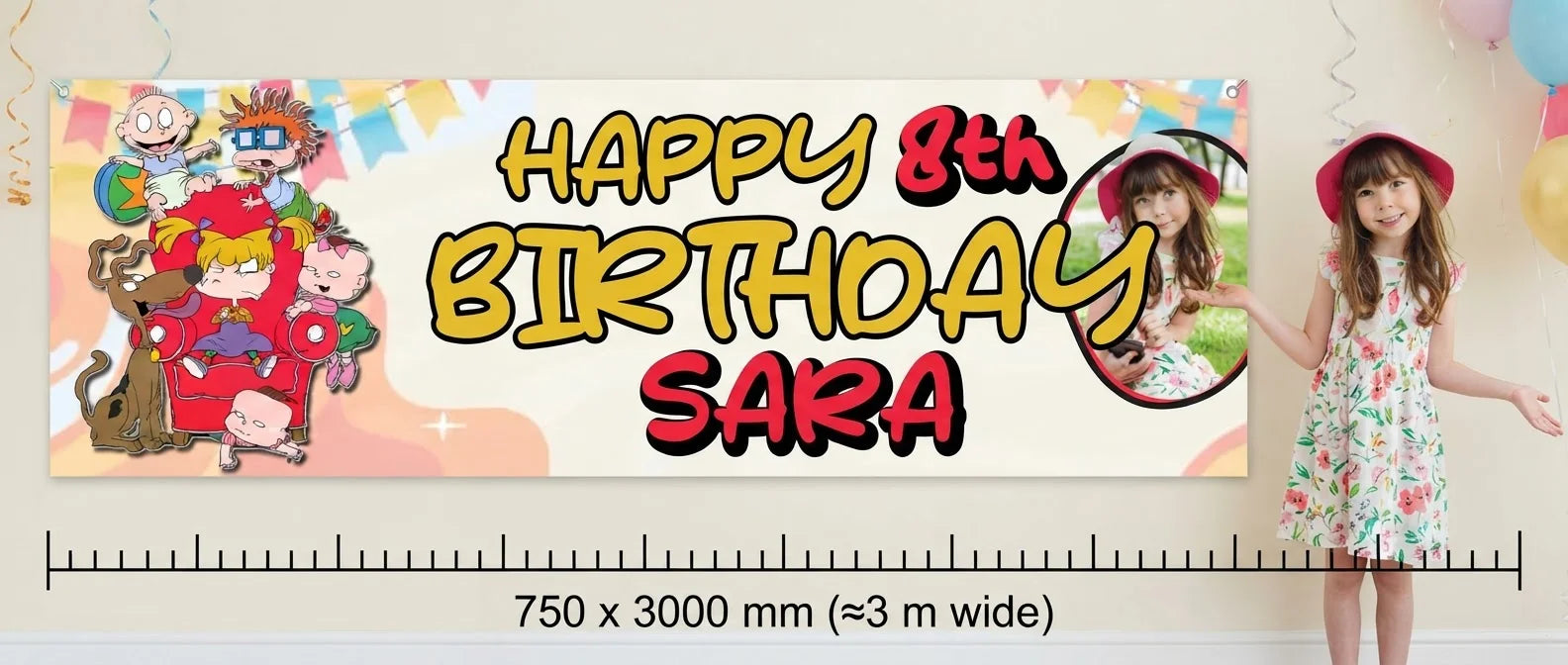 Person standing beside the Rugrats Birthday Banner for scale, with size guide showing 750 x 3000 mm