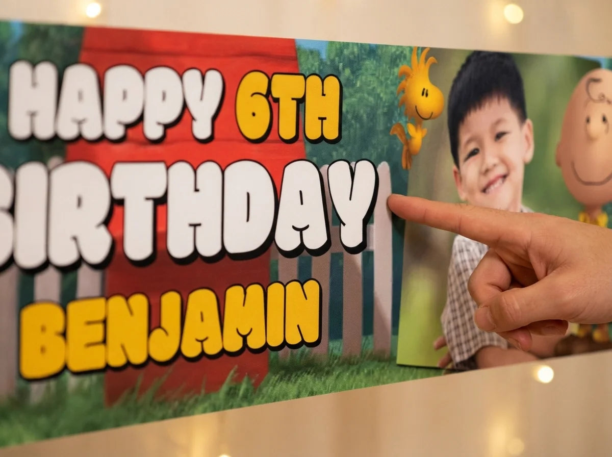 Close-up of the personalised name and photo printed on the Snoopy Birthday Banner