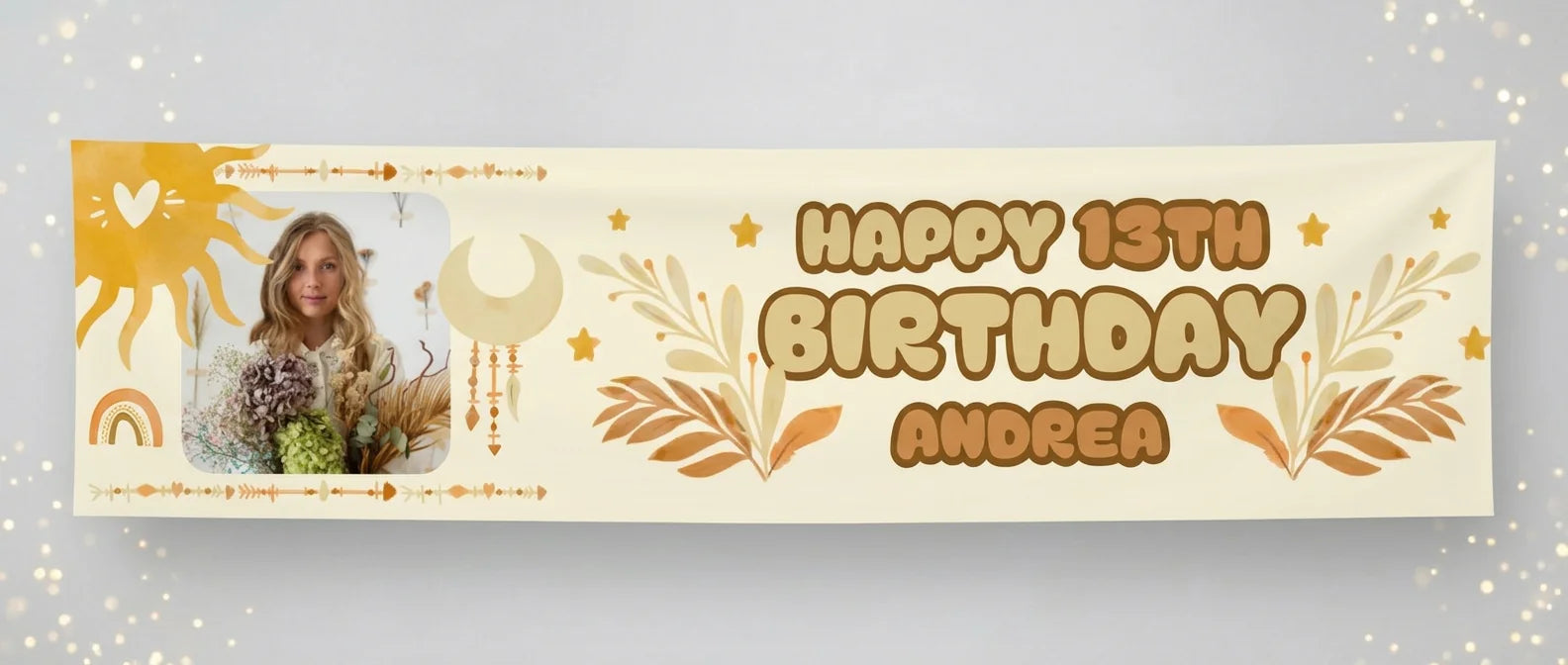 Personalised boho theme birthday banner printed with a custom name, age and photo, hanging against a plain studio background