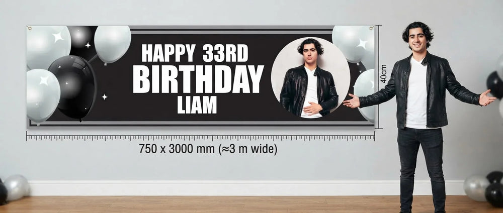 Person standing beside the Black and White Theme Birthday Party Banner for scale, with size guide showing 750 x 3000 mm
