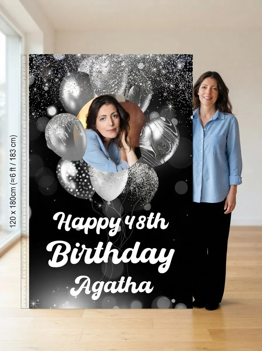 Person standing beside the Silver Balloons Birthday Party Mega Card for scale in a size guide