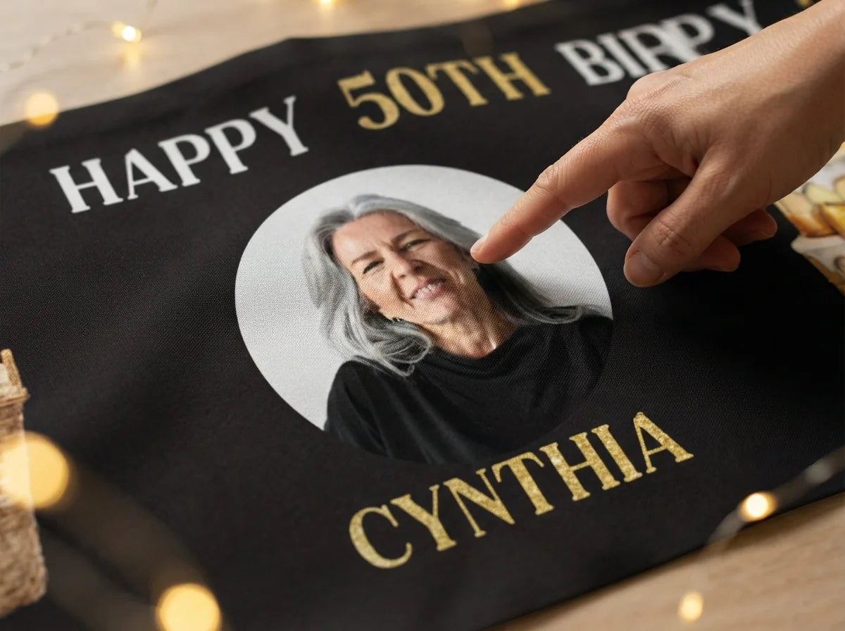 Close-up of the personalised name and photo printed on the Golden Cake Birthday Party Banner