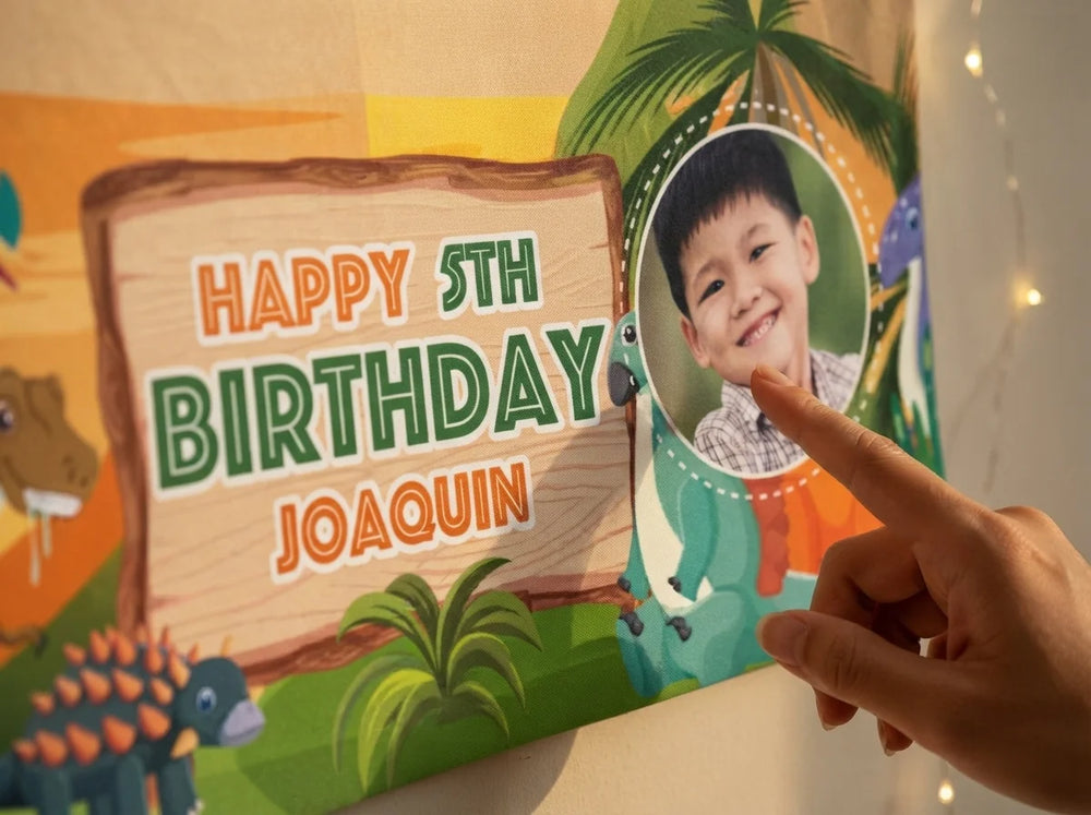 Close-up of the personalised name and photo printed on the Dinosaurs Birthday Banner