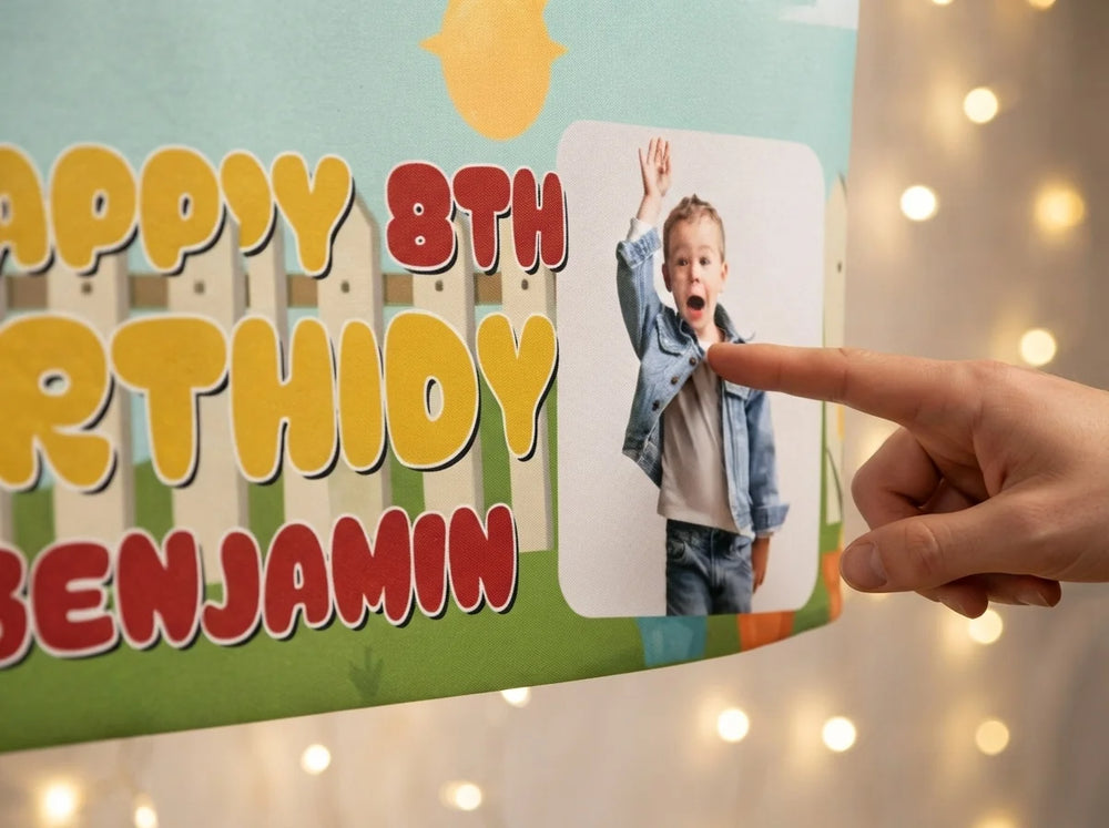 Close-up of the personalised name and photo printed on the Larva Birthday Banner