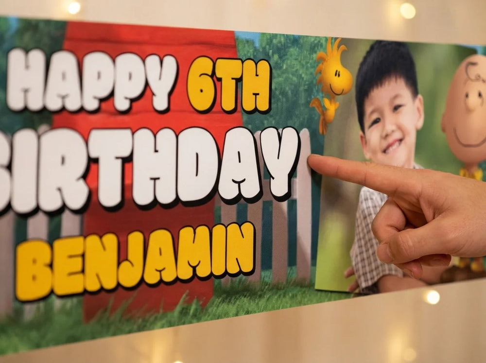 Close-up of the personalised name and photo printed on the Snoopy Birthday Banner