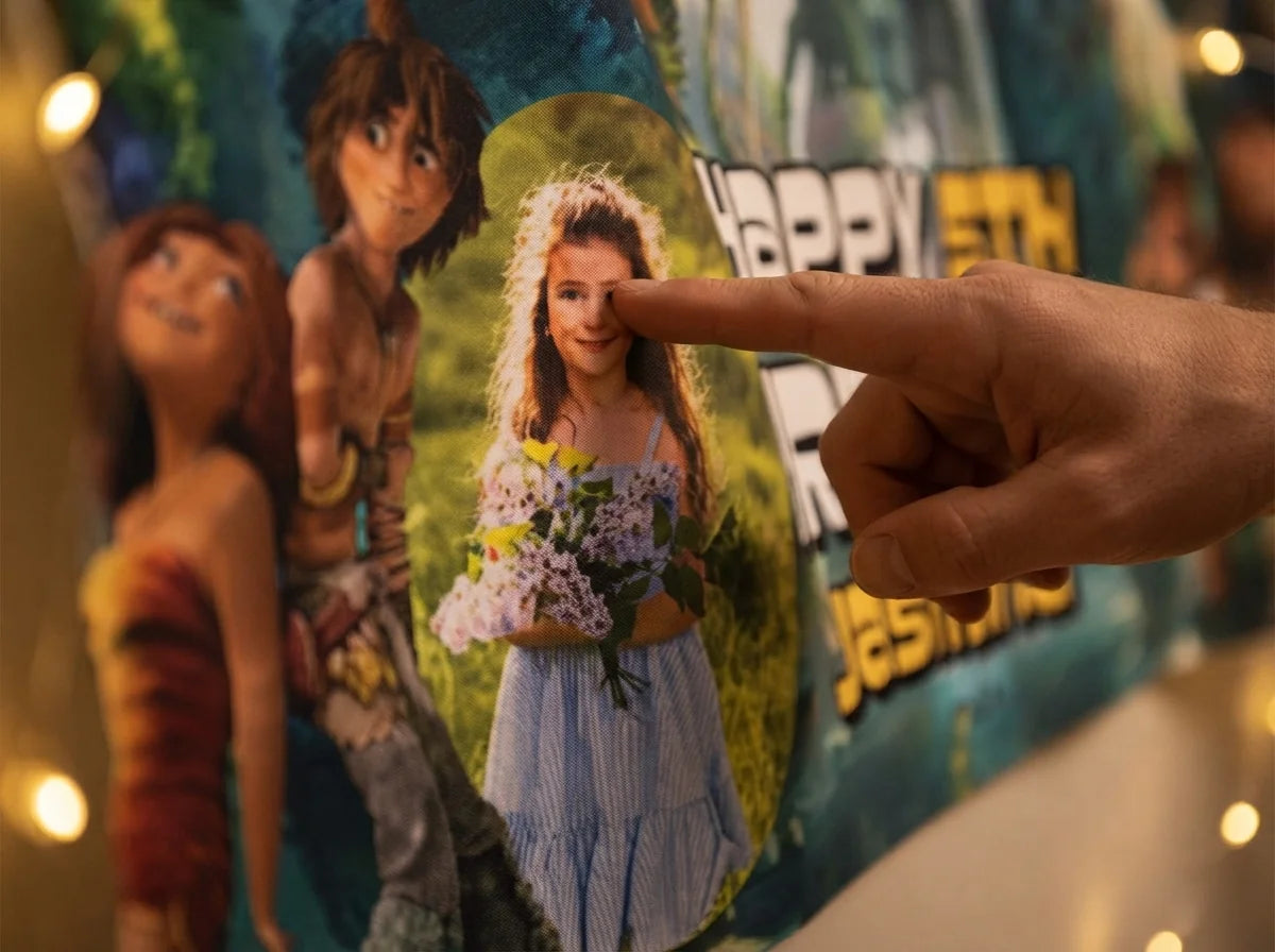 Close-up of the personalised name and photo printed on the The Croods Birthday Banner