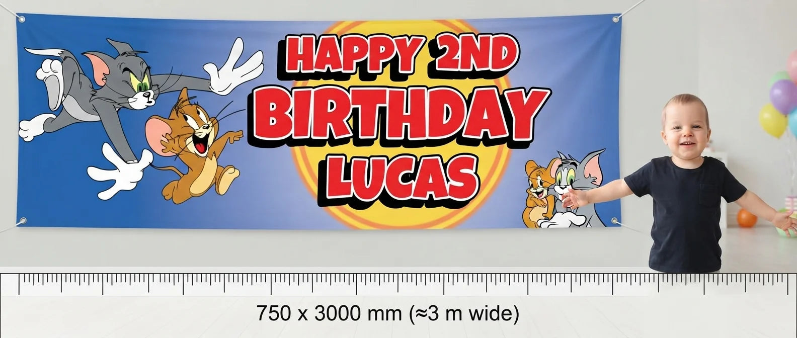 Person standing beside the Tom and Jerry Birthday Banner for scale, with size guide showing 750 x 3000 mm