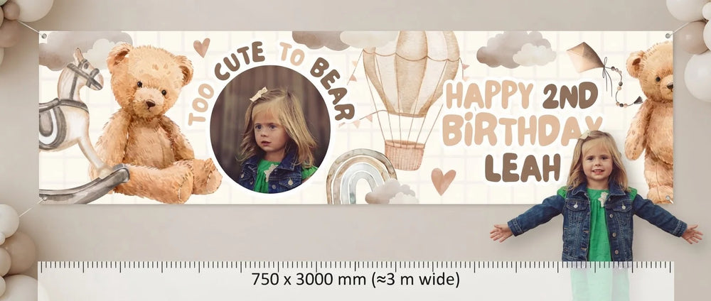 Person standing beside the Too Cute To Bear Birthday Party Banner for scale, with size guide showing 750 x 3000 mm