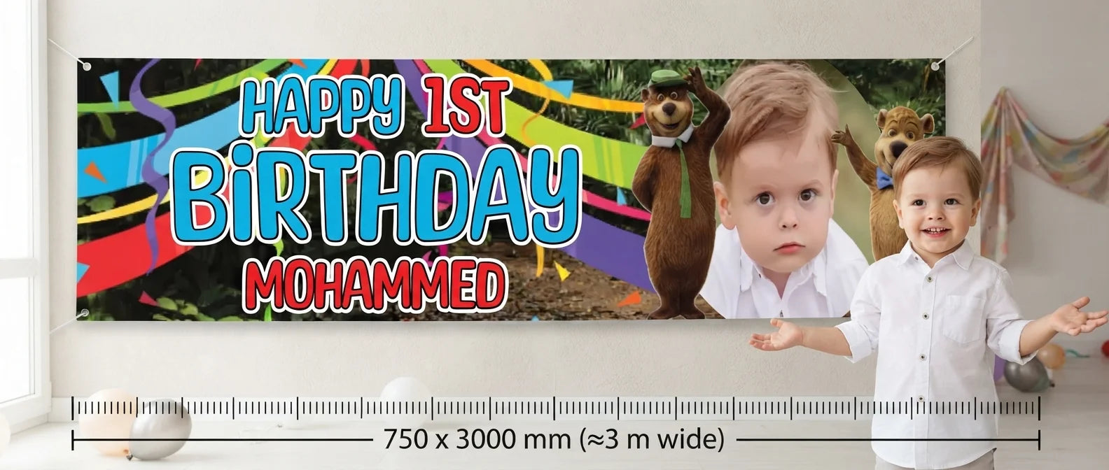 Person standing beside the Yogi Bear Birthday Banner for scale, with size guide showing 750 x 3000 mm